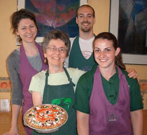 Owner Laura Bishop (holding our new kamut-crust pizza) with friendly Heartwood staff.