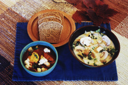 A meal of Heartwood's Original Roasted Tofu Stroganoff, Spicy Cauliflower Italiano, and Sourdough Bread